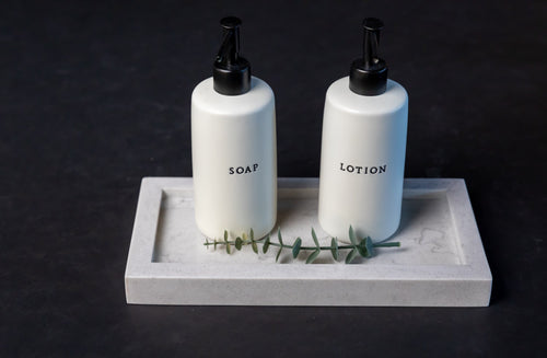 Third Coast Stone quartz bathroom tray organizer styled with soap and lotion dispensers